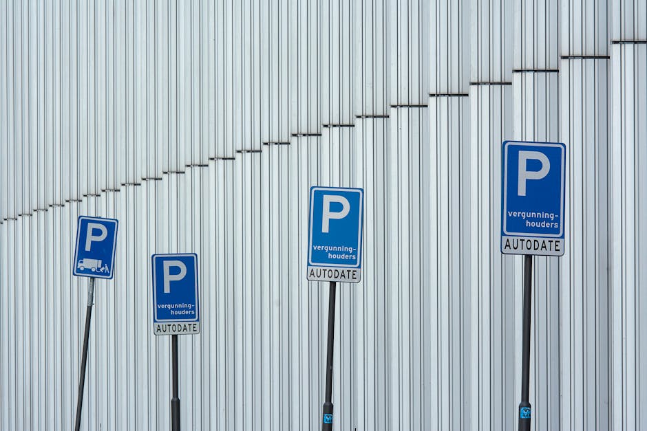 A green and white parking restriction sign mounted on a metal pole outdoors, indicating a two-hour parking limit from 8 am to 8 pm, Monday to Saturday, with a note that parking is not permitted on Sun